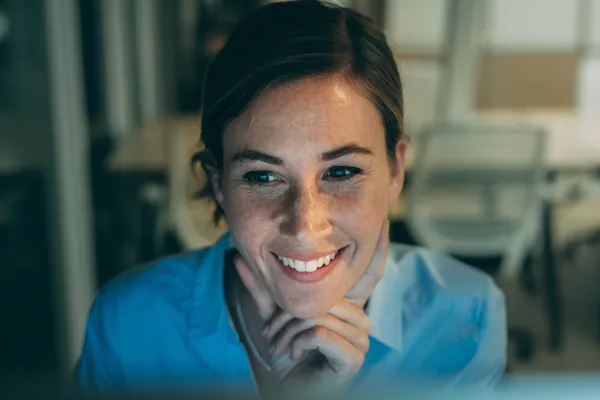 Girl smiling at a computer