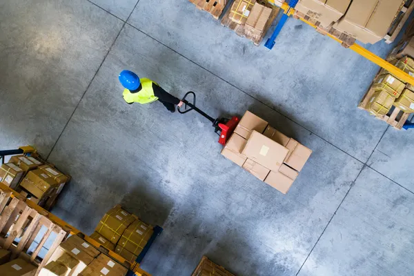 Man pulling boxes in a warehouse